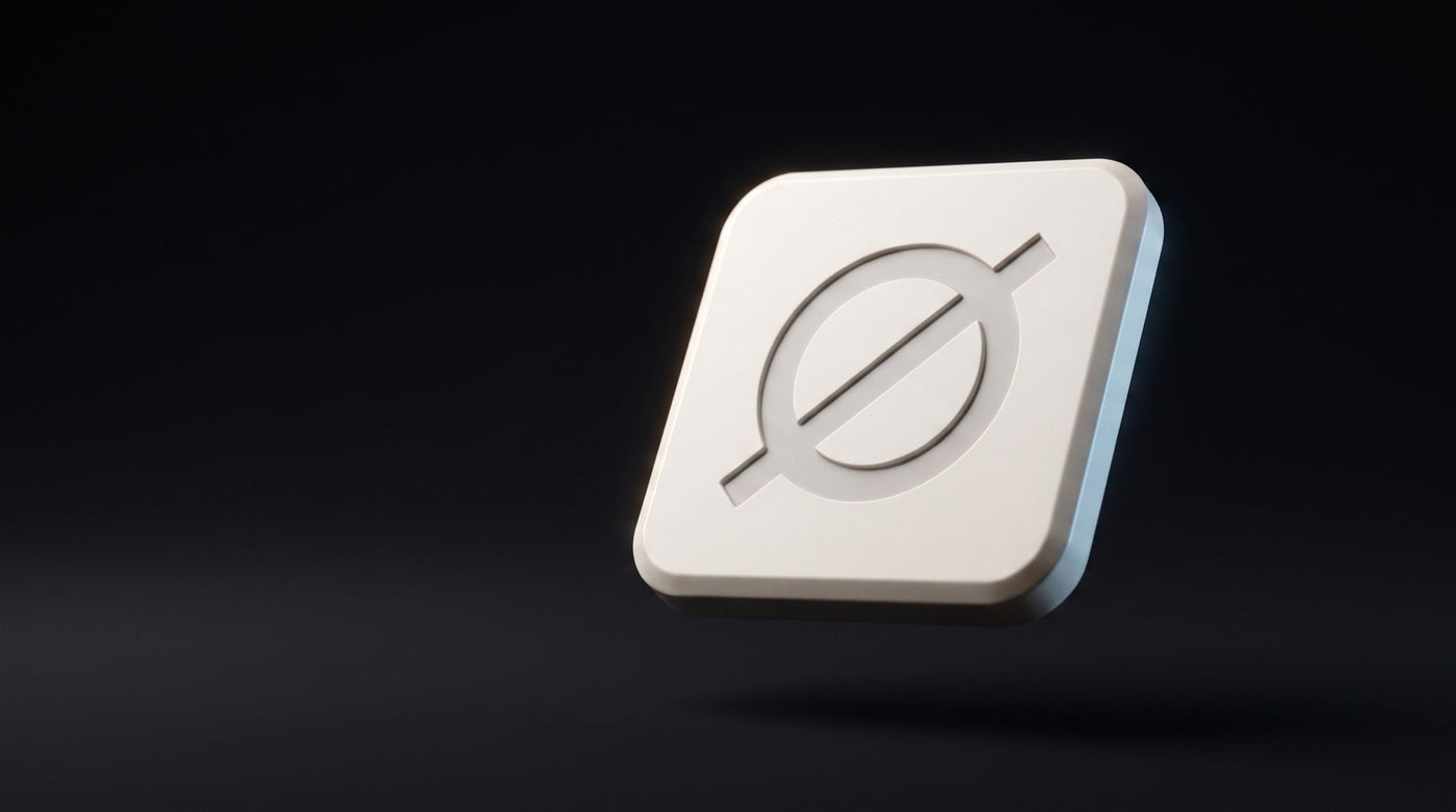 Null Tag in bone-white matte polymer, engraved Ø mark catching a rim light