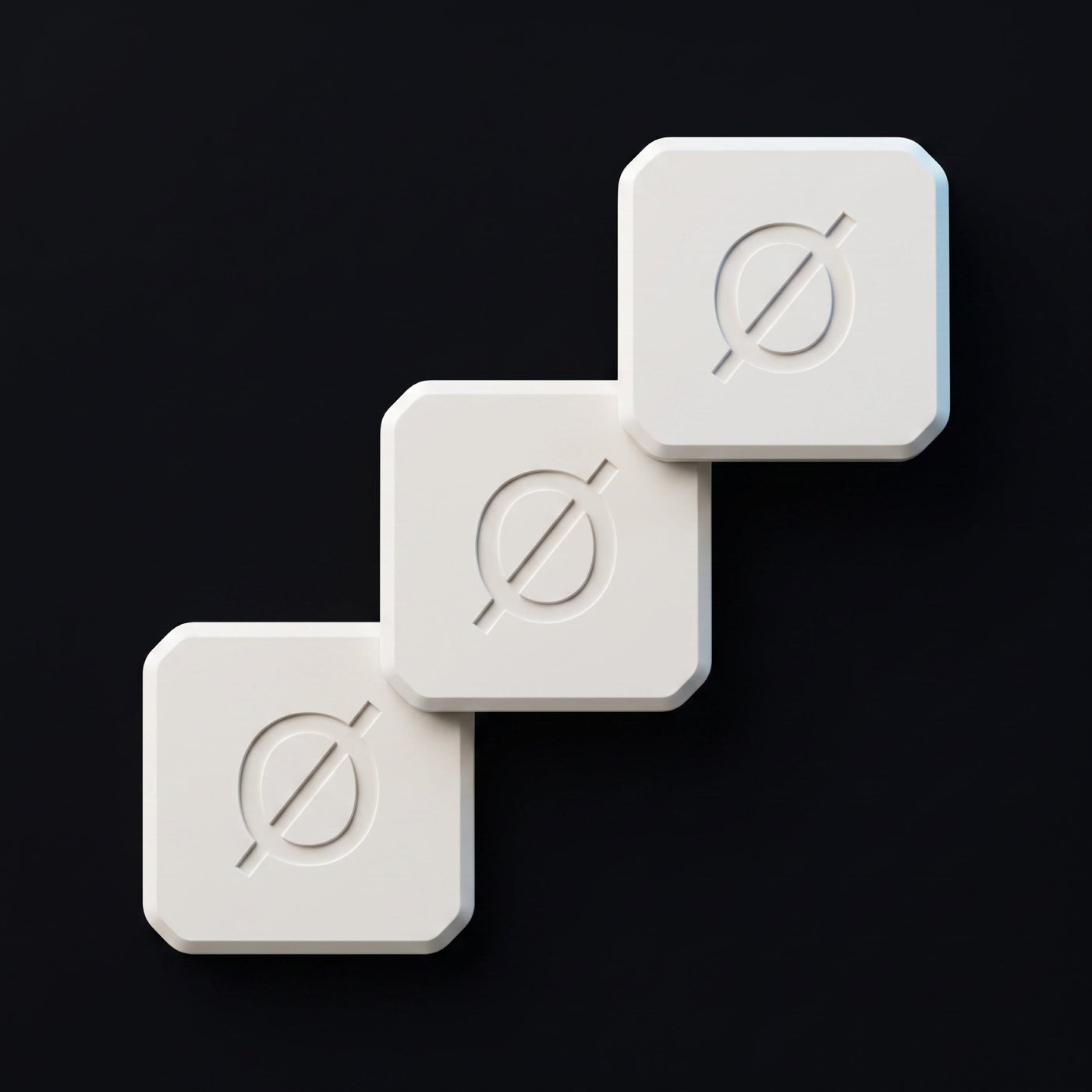 Three white Null Tags arranged on an obsidian surface