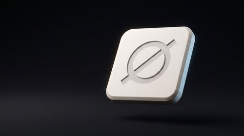 Null Tag in bone-white matte polymer, engraved Ø mark catching a rim light